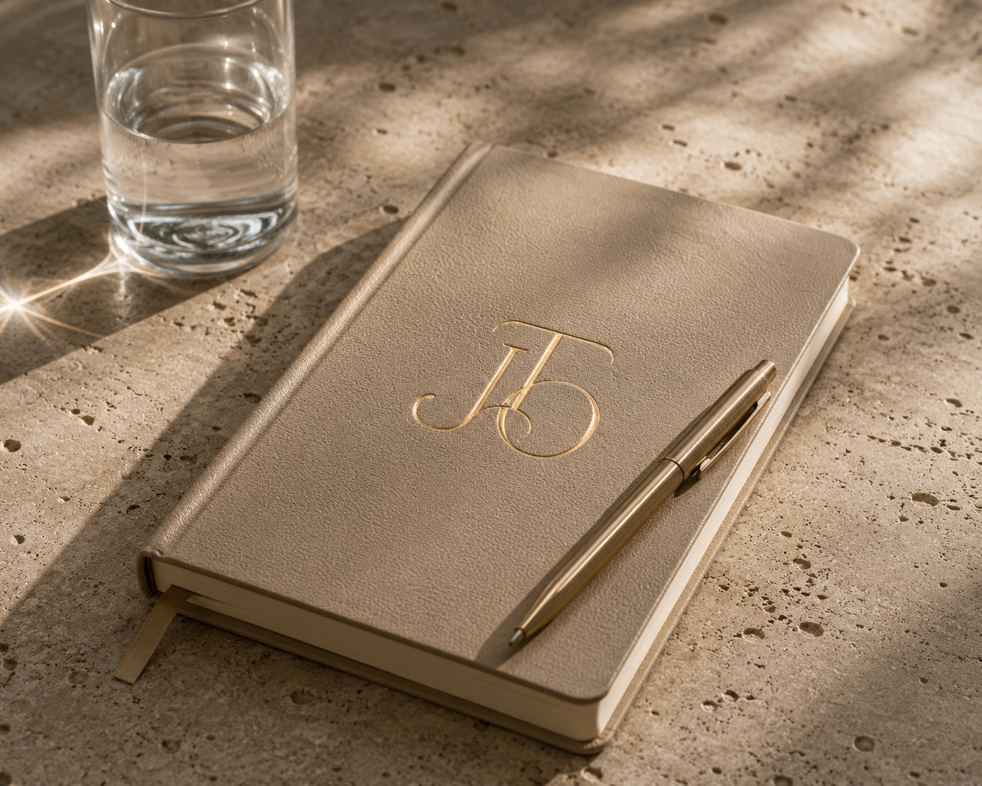 Notebook and pen on a sunlit stone surface